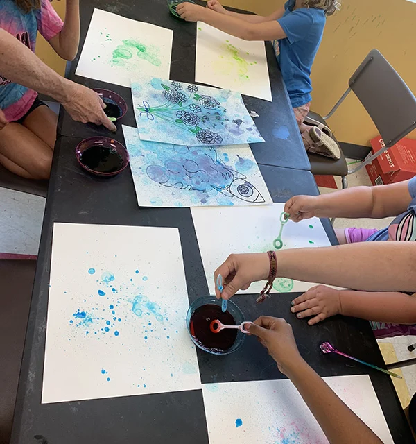 Kids drawing together at the PACA summer art program