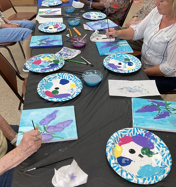 Children showing their artwork at the PACA summer art program
