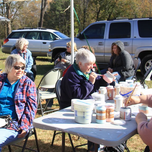 Students glazing raku pottery at a PACA workshop