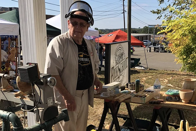 Folk school craftsman demonstrating traditional woodworking at a Pickens County festival
